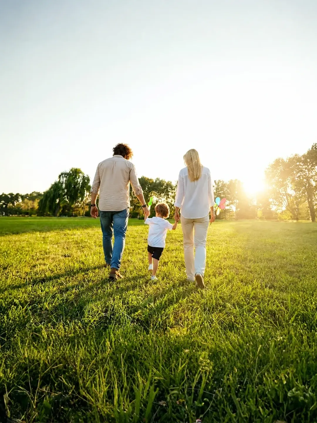 Family walking through countryside at sunset, suggesting calm renewal after separation