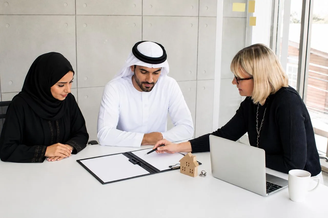 An adviser talking a couple through documents at a table